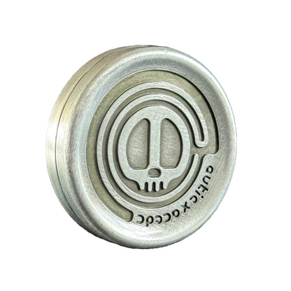Front view of the Skull Coin highlighting its symmetrical build and brushed metallic finish.
