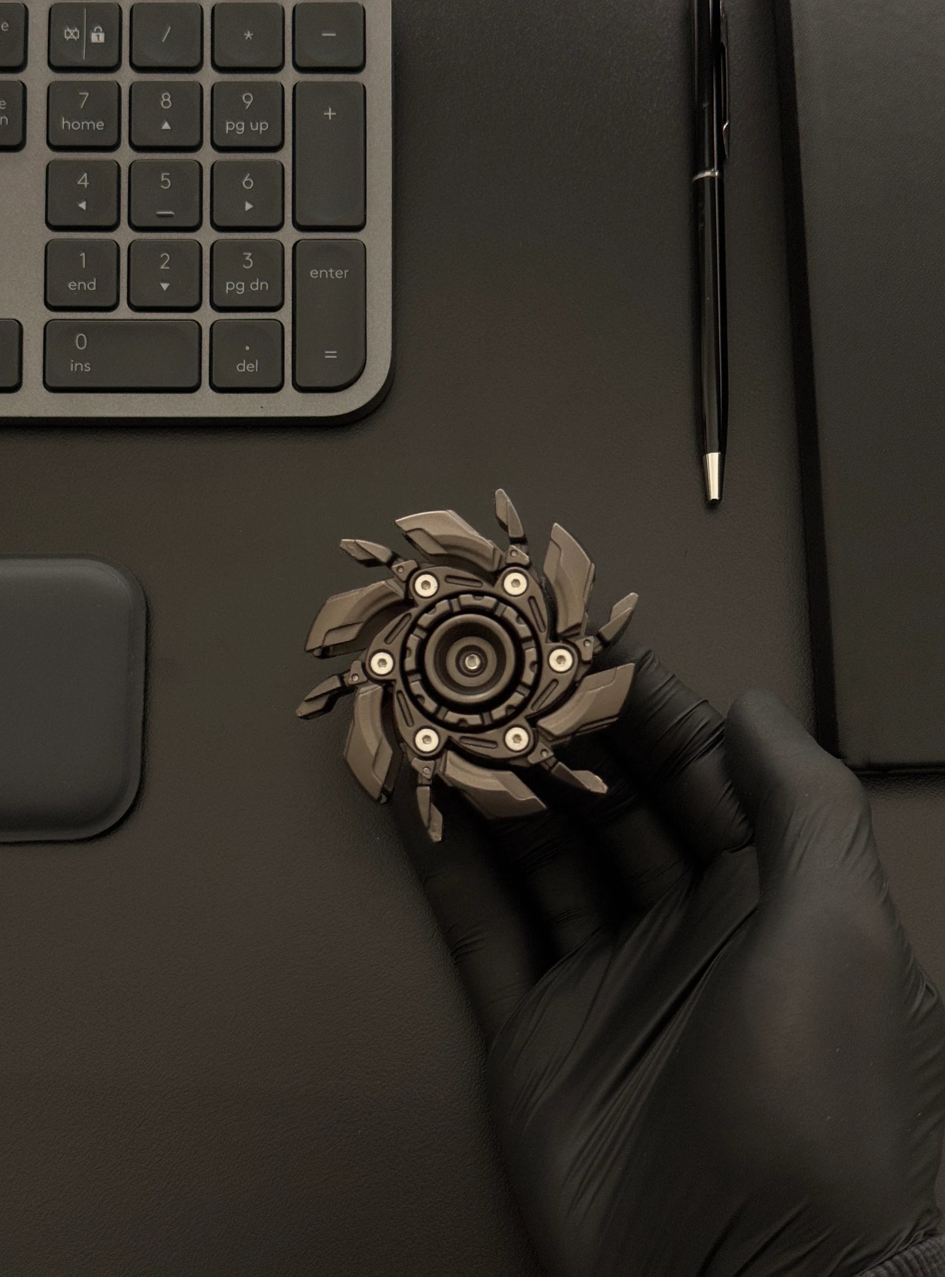 A hand holding the expanding spinner, emphasizing its tactile feedback and relaxing weight
