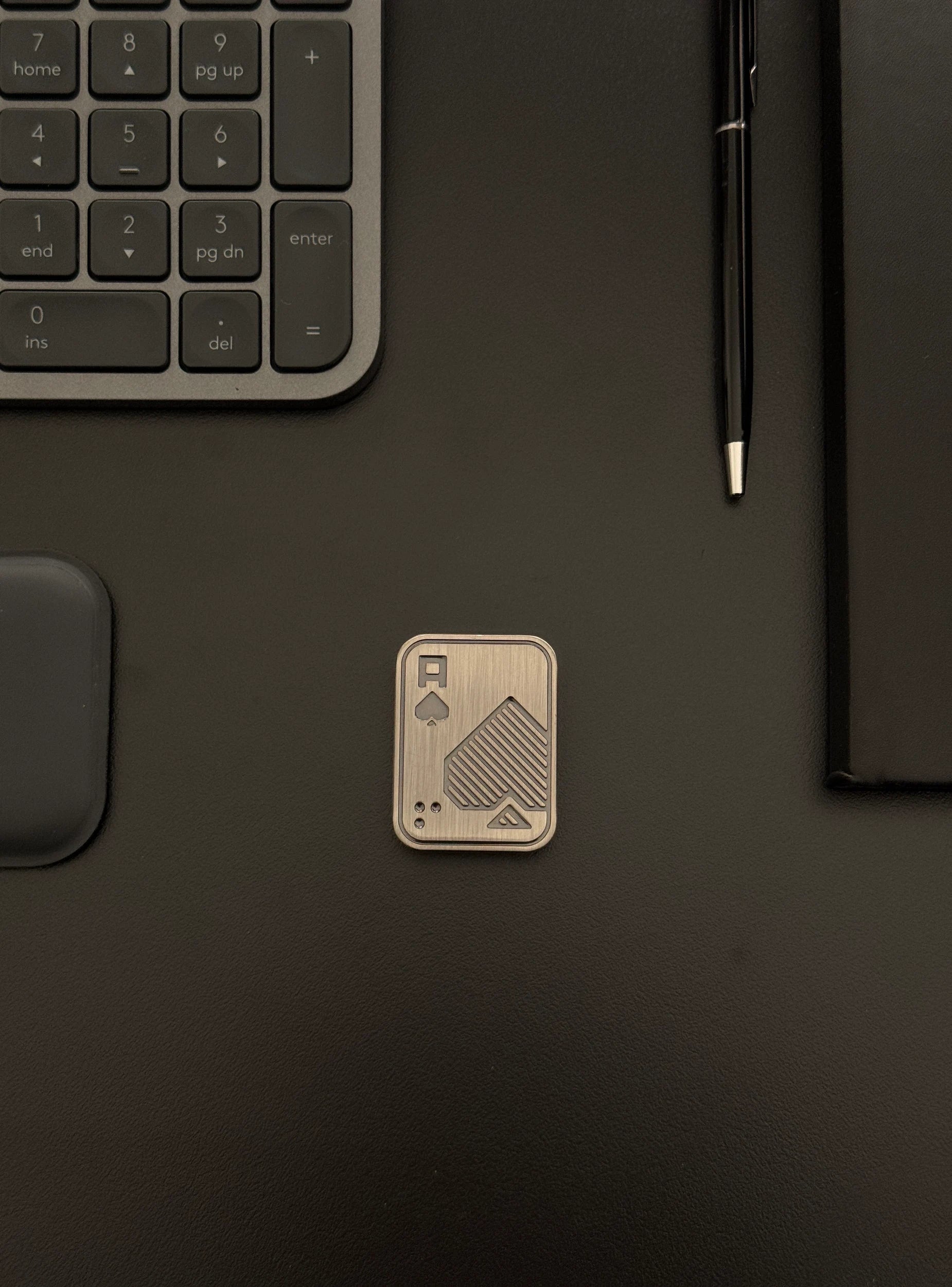 Fidget toy placed on a desk with keyboard and notebook setup, emphasizing discreet integration into daily routines.
