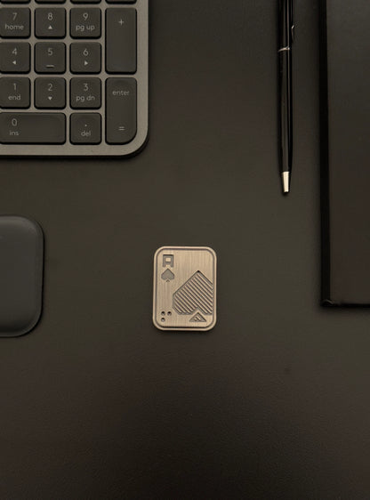 Fidget toy placed on a desk with keyboard and notebook setup, emphasizing discreet integration into daily routines.
