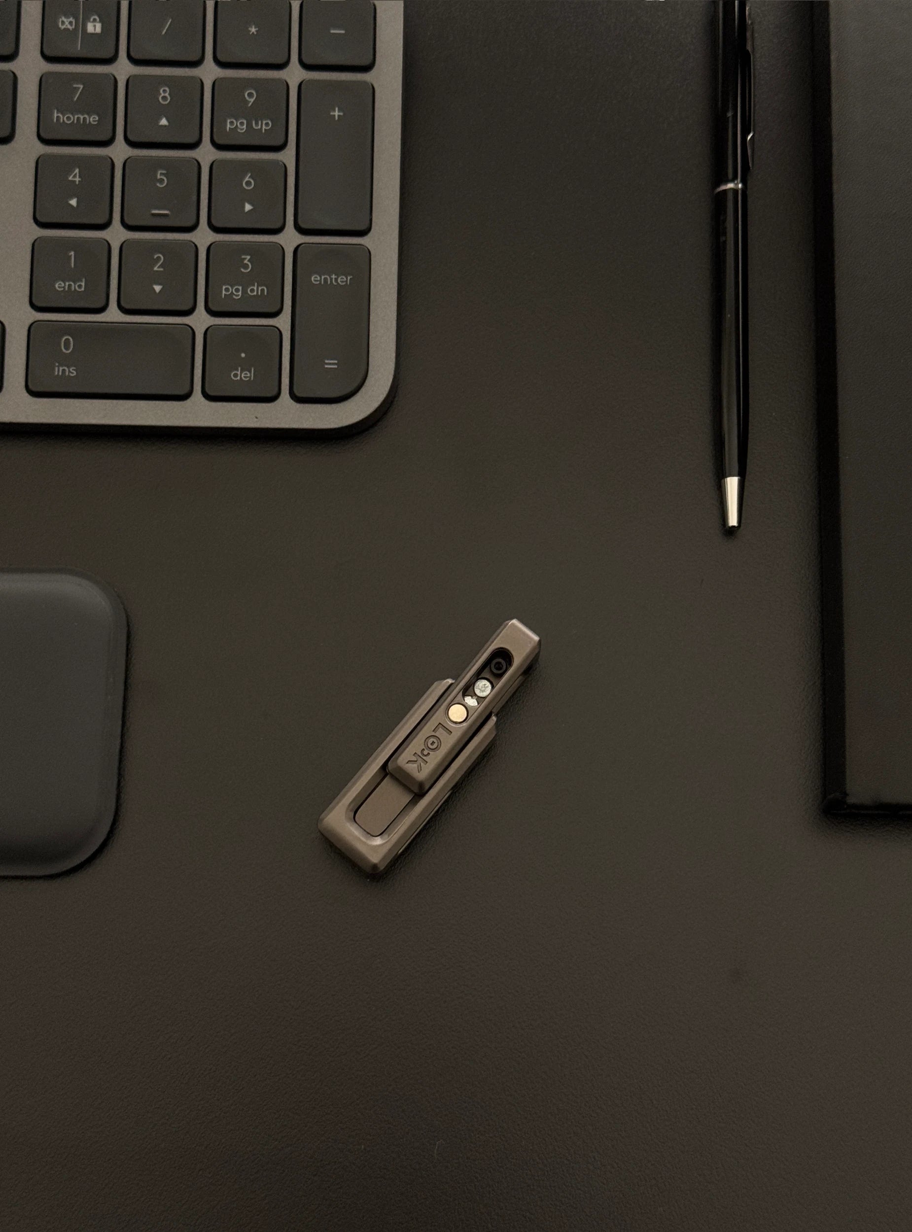 xLock Tower Fidget placed on a desk with a keyboard and notebook, depicting its discreet presence in a professional environment.​
