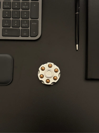 Spinner placed on a work desk beside a keyboard, illustrating everyday use.
