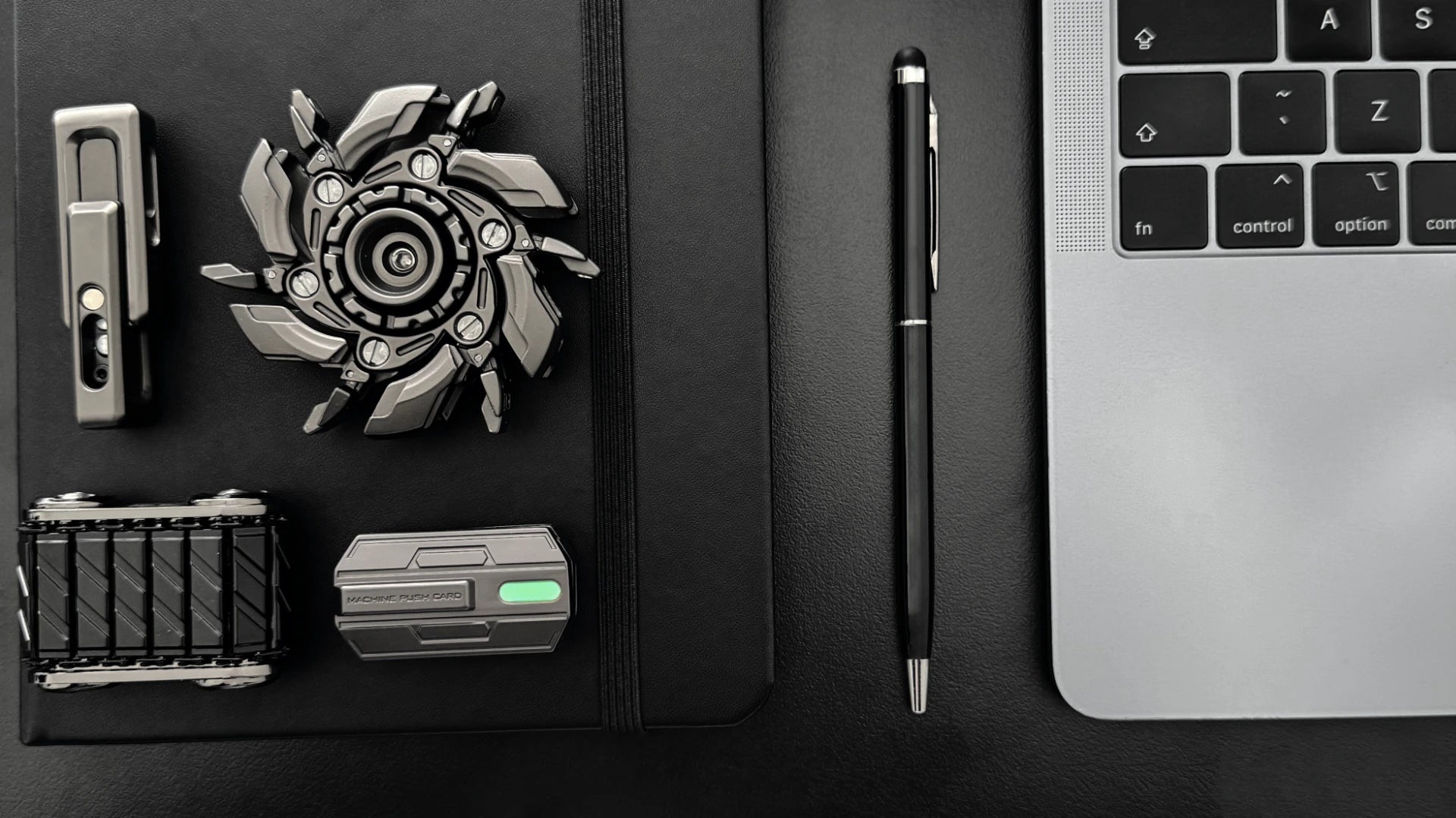 Fidget toys next to macbook notebook and pen 